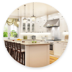 A fully lit up kitchen with long hanging lights