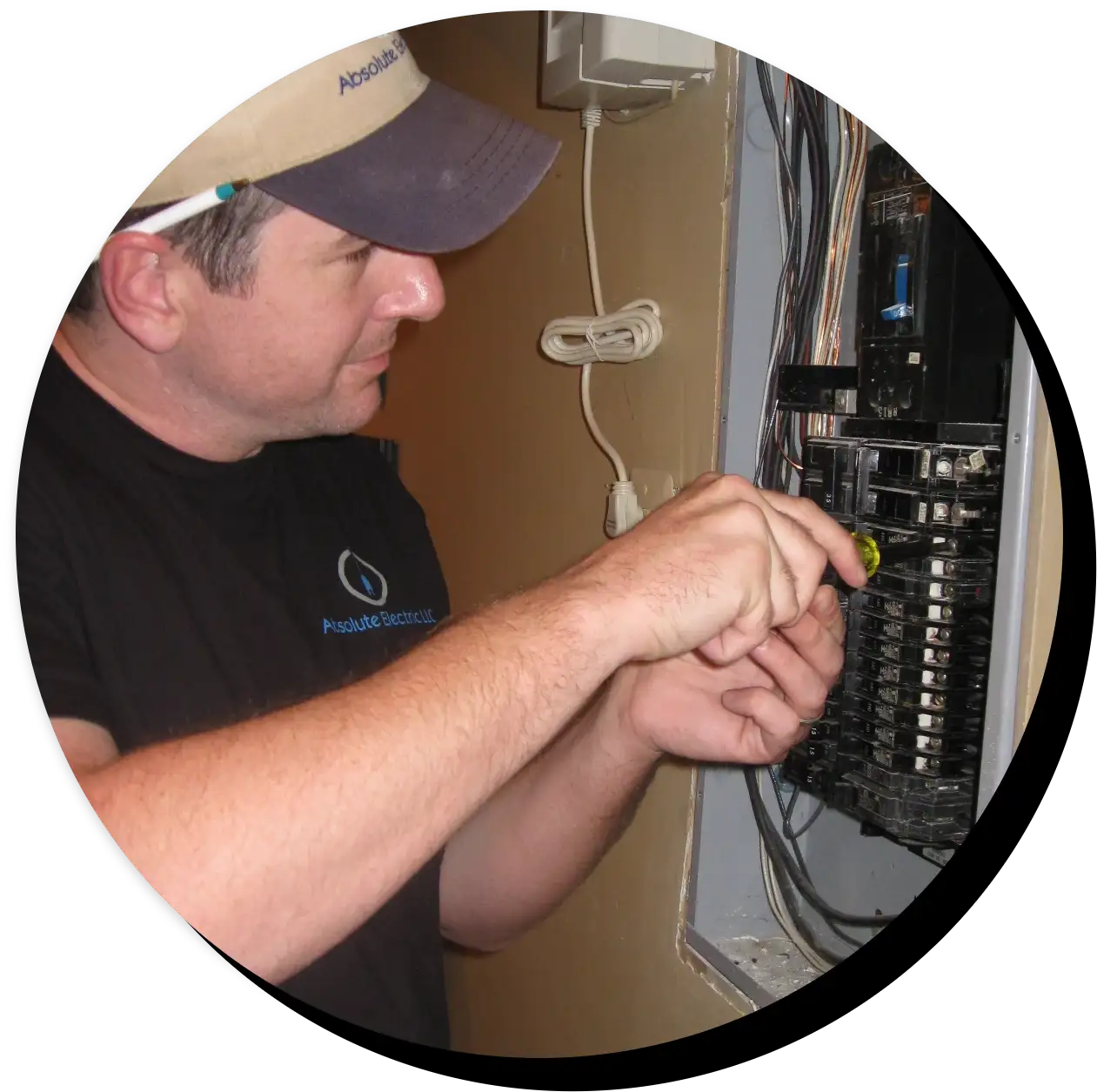 Absolute Electric electrician working in breaker box