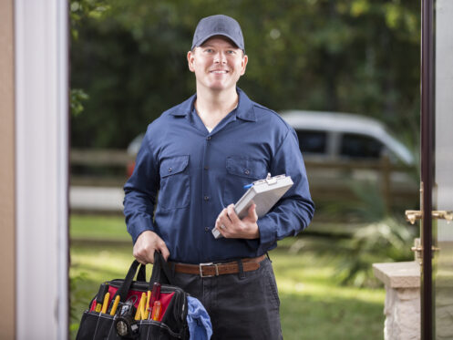 Licensed electrician arriving at a Fort Myers home with tools and inspection clipboard